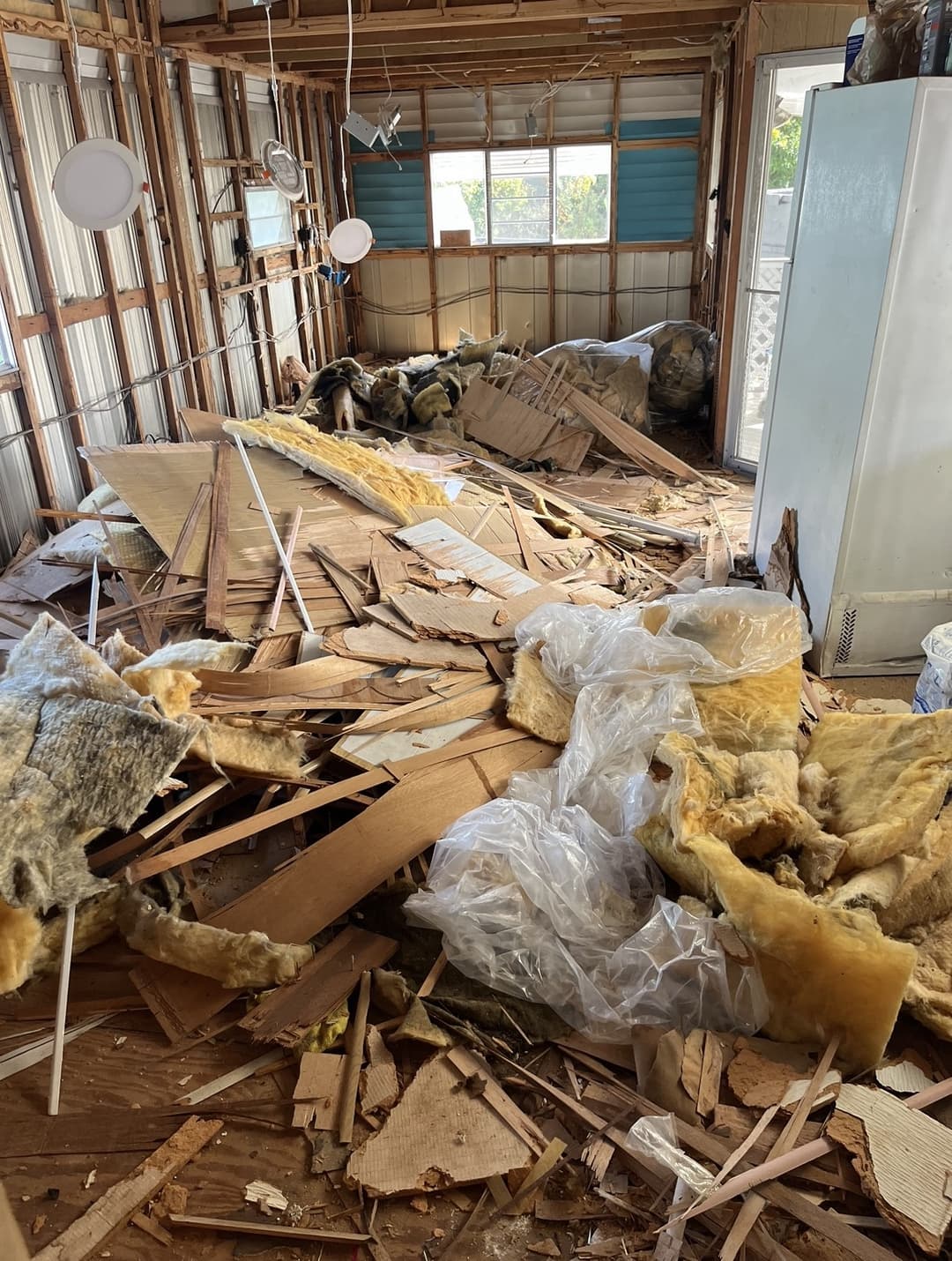 Garage full of wood, cardboard, and insulation junk